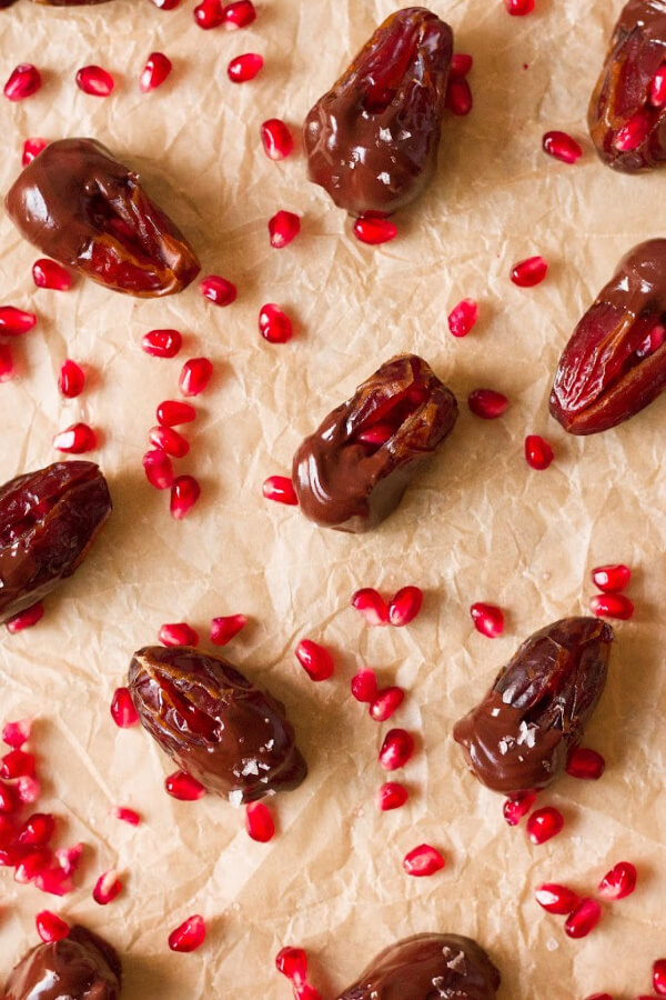 Chocolate dipped dates with pomegranate arils.