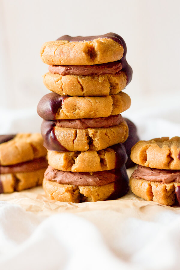 Peanut butter sandwich cookies filled with chocolate cream and half dipped in chocolate.