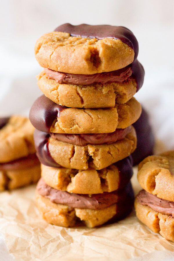 Peanut butter sandwich cookies filled with chocolate cream and half dipped in chocolate.