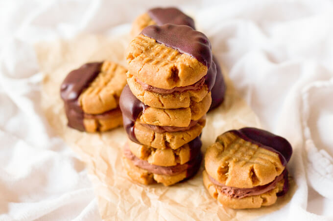 Peanut butter sandwich cookies filled with chocolate cream and half dipped in chocolate.