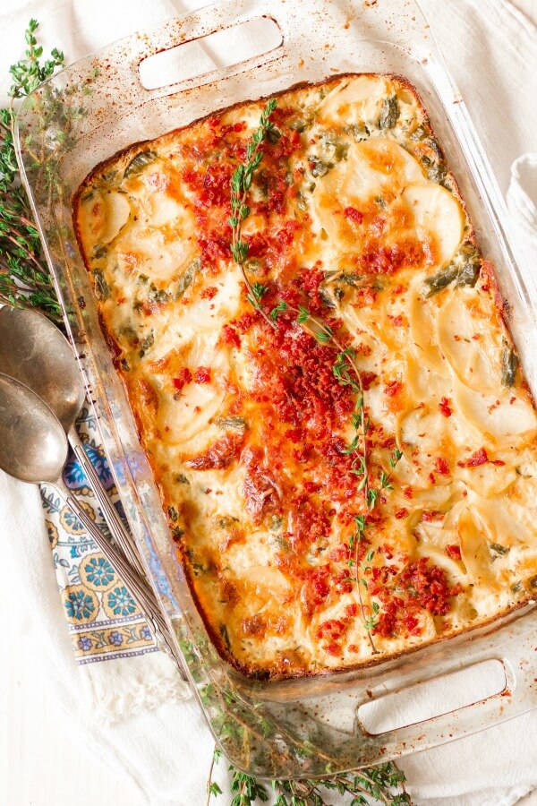 Scalloped potatoes with bacon and thyme on top.