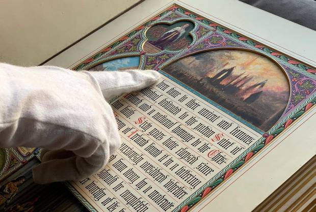 Guinness Archive Manager Eibhlin Roche points to a hand-painted book given to Benjamin Lee Guinness. Photo: Pól Ó Conghaile