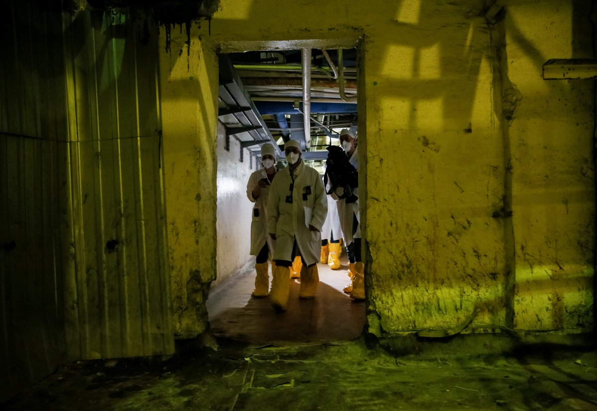 Journalists walk through the corridor of one of Chernobyl's reactors. (Gleb Garanich/Reuters)