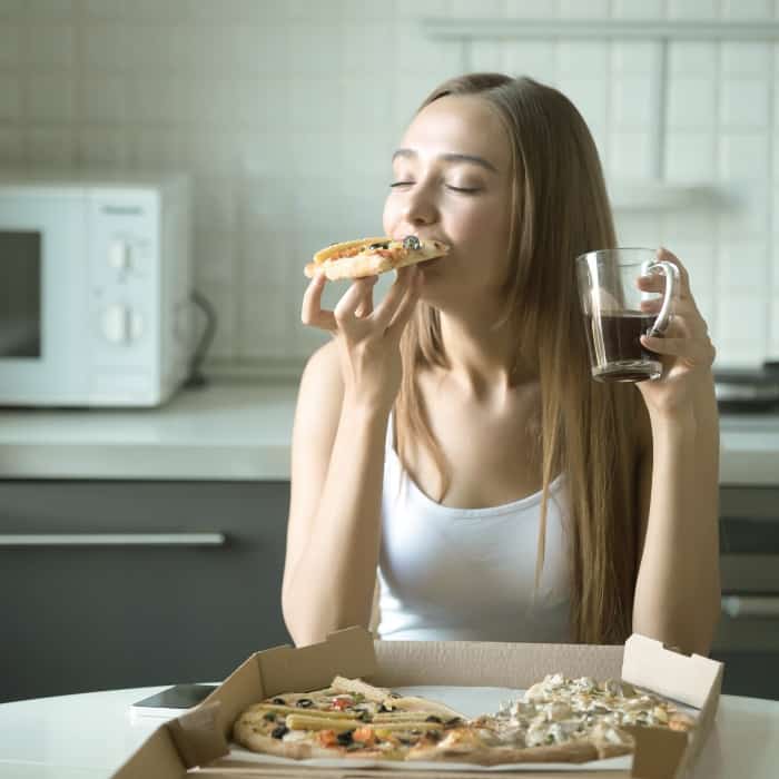 woman eating pizza