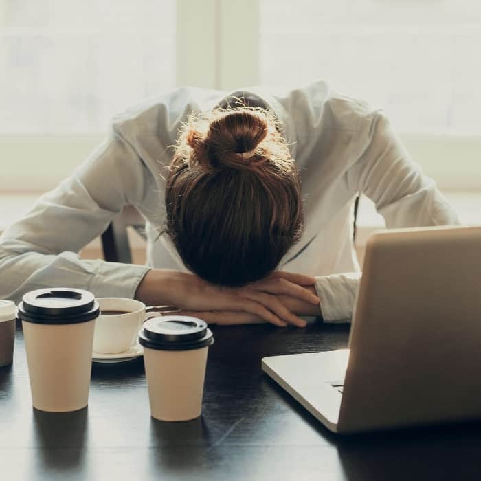 woman sleeping at her desk at work