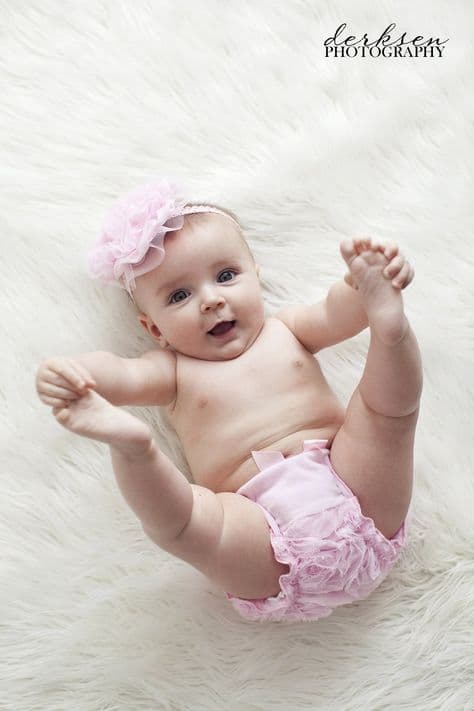 baby with pink ruffle diaper and matching head piece