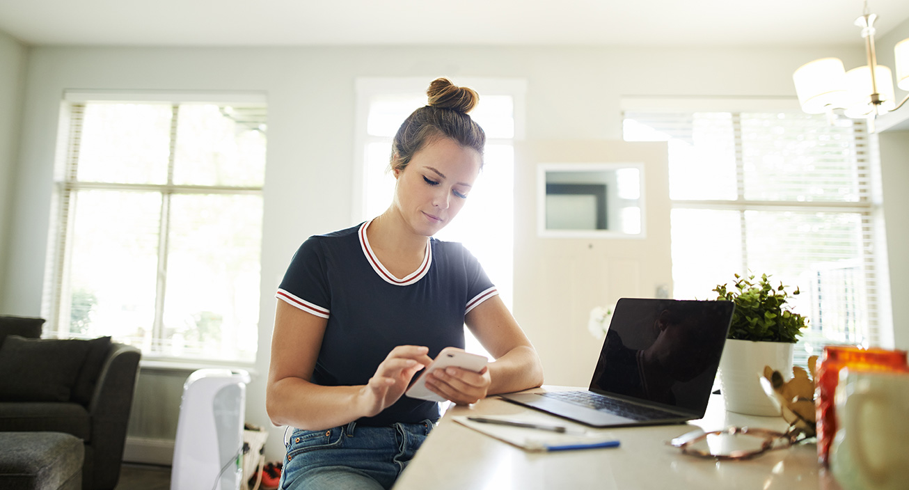 women checking finances from her phone 