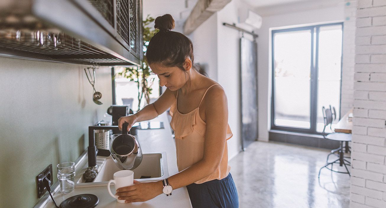 A girl making her own coffee at home