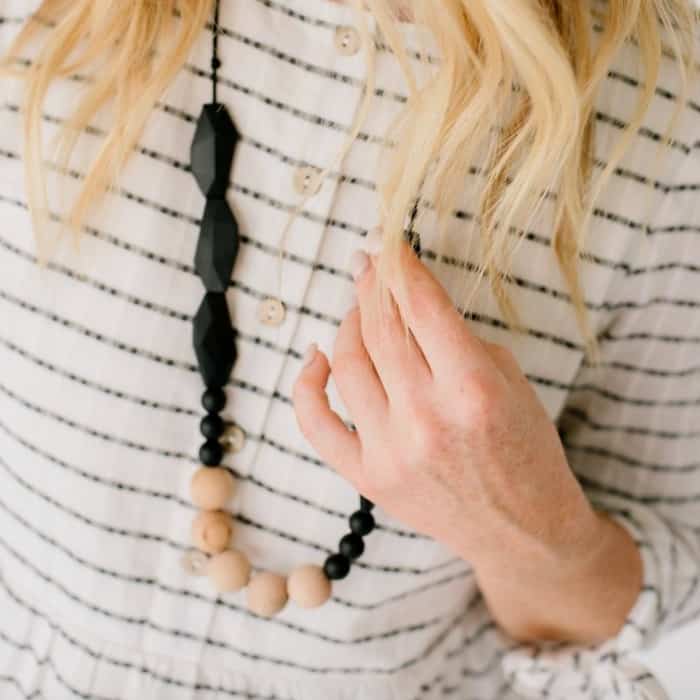 mom wearing teething necklace she got as a baby shower gift