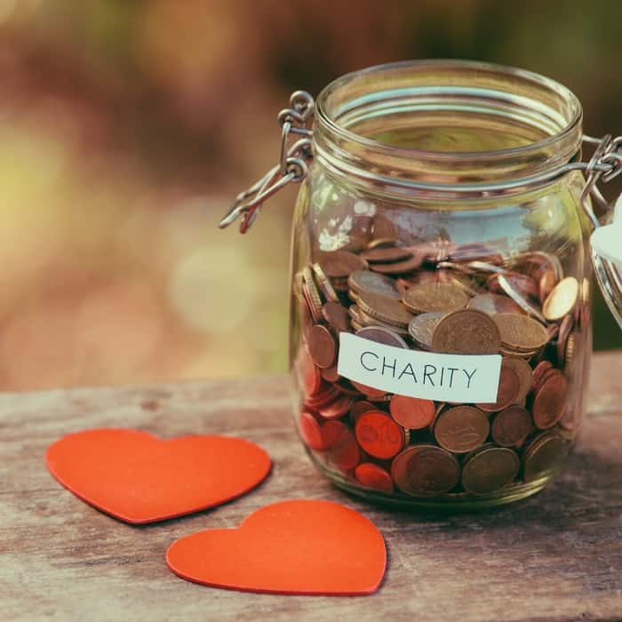 jar full of coins that says 'charity'